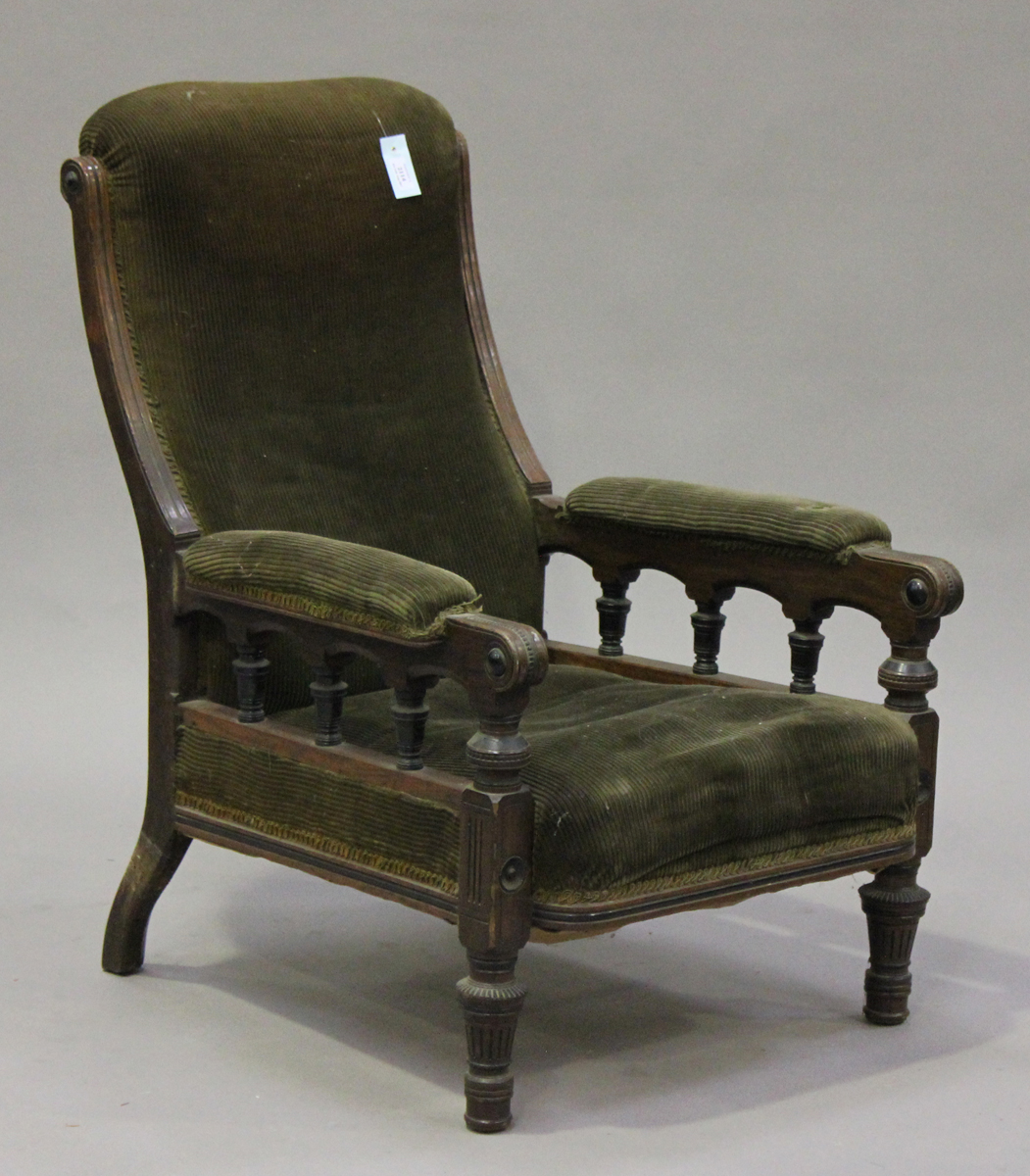 A late Victorian Aesthetic period oak and ebonized library armchair, the seat, back and arms