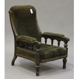 A late Victorian Aesthetic period oak and ebonized library armchair, the seat, back and arms