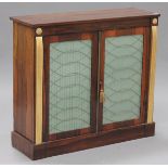 A Regency rosewood side cabinet, fitted with a pair of panelled doors inset with pleated fabric,