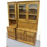 A late 20th century Ercol elm side cabinet, fitted with glazed doors and a fall front above