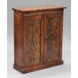 A 19th century rosewood side cabinet fitted with a pair of panelled doors, on a plinth base,