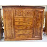 An early Victorian mahogany wardrobe, the moulded pediment above a cupboard and drawers, flanked