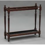 An Edwardian mahogany three-division stick stand with turned supports, height 72cm, width 76cm.