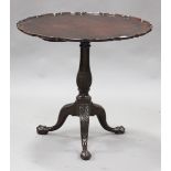 A George III mahogany tip-top circular supper table, the dished piecrust top raised on a turned