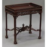 A 20th century Victorian style mahogany silver table with pierced fretwork decoration, raised on