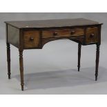 An early 19th century bowfront kneehole side table fitted with three frieze drawers, on turned