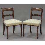 A set of six Regency figured mahogany and brass inlaid bar back dining chairs with carved roundel