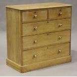 A Victorian pine chest of two short and three long drawers with brass handles, on a plinth base,