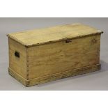 A 19th century pine trunk, fitted with a hinged lid and carrying handles, height 45cm, width 93cm.