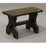 A 19th century and later oak bench with twin plank supports, height 49cm, width 77cm (alterations).