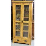 A modern oak glazed cabinet fitted with two doors and two drawers, height 190cm, width 89cm,