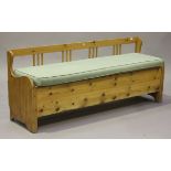 A 20th century stripped pine box seat settle on block legs, height 74cm, width 184cm.Buyer’s Premium