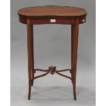 An Edwardian satinwood kidney shaped occasional table with ebony line inlaid borders, raised on