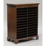 A 20th century reproduction mahogany filing cabinet, the moulded top above twenty-six open