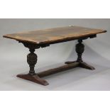 An early/mid-20th century Jacobean Revival oak refectory table on turned baluster legs and bracket