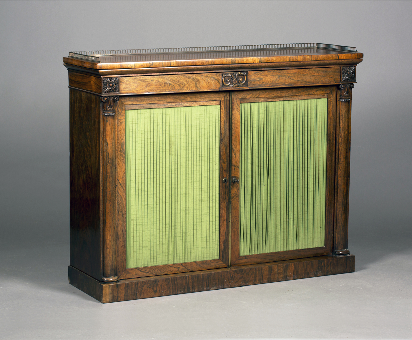 A Regency rosewood side cabinet, the top with a pierced brass gallery above two concealed frieze