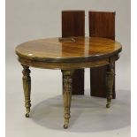A late Victorian mahogany oval extending dining table with two extra leaves, raised on reeded and