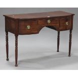 A George IV mahogany break bowfront side table, fitted with three frieze drawers, raised on turned