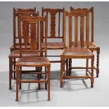 A set of four George V Arts and Crafts style oak dining chairs and two similar chairs, together with