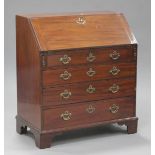 A George III mahogany bureau, the fall flap enclosing a fitted interior above four long drawers,