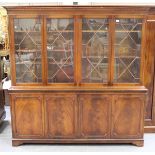 A late 20th century George III style mahogany four-section bookcase cabinet on bracket feet,