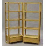 A pair of modern oak open bookcases, each fitted with a drawer, height 175cm, width 70cm.Buyer’s