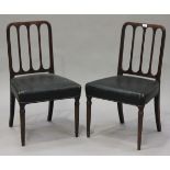 A set of six George III mahogany comb back dining chairs, the padded seats upholstered in black