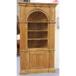 A 20th century pine floor standing corner cabinet, the moulded pediment above an arched sunburst