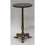 A Regency simulated rosewood wine table, the circular top above a turned stem and triform base,