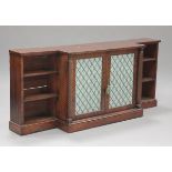 A William IV and later mahogany breakfront bookcase, fitted with a pair of doors inset with gilt