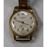 An International Watch Co 18ct gold circular cased lady's wristwatch, the signed circular silvered