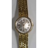 A Movado French gold lady's bracelet wristwatch, the signed circular silvered dial with baton shaped