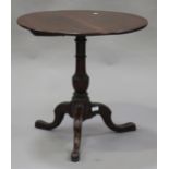 A George III mahogany circular tip-top wine table, raised on a turned column and tripod cabriole