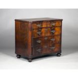 An early 19th century French figured mahogany concave fronted secrétaire chest of four drawers, on