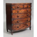 A Victorian break bowfront chest of two short and four long drawers, the corners with applied turned