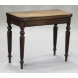 A William IV mahogany fold-over card table, the hinged top raised on carved acanthus leaf and spiral