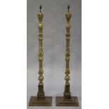 A pair of 18th century Continental giltwood and gesso altar sticks, later converted to lamp