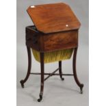 An early Victorian mahogany work table, fitted with a hinged surface above two drawers and a