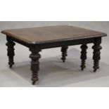 A large late Victorian oak extending dining table, the moulded top with four extra leaves, raised on