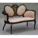 An Edwardian ebonized and chinoiserie decorated three piece salon suite, comprising a settee and a