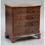 A 20th century reproduction mahogany bowfront chest of four graduated long drawers, on bracket feet,