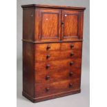 A Victorian mahogany cabinet-on-chest by 'Heal and Son London', the moulded top above a pair of