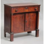 A 19th century Empire style mahogany side cabinet, fitted with a drawer and cupboard, on block legs,