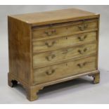 A George III mahogany chest of four graduated long drawers, fitted with a brushing slide, on bracket