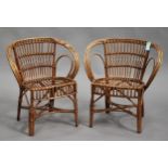 A pair of 20th century tub back wicker chairs with 'X' frame stretchers, height 75cm, width 66cm.