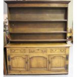 A late 18th century oak dresser base, the moulded top above an arrangement of three drawers and