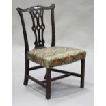 A George III Chippendale period mahogany pierced splat back dining chair with carved decoration, the