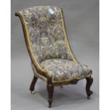 An early Victorian rosewood slipper chair with carved scroll decoration, the upholstered seat and