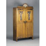 An Edwardian Arts and Crafts oak and copper mounted hall cupboard, attributed to Shapland & Petter