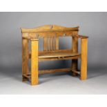 An Edwardian Arts and Crafts oak hall bench, possibly made by William Birch and designed by E.G.